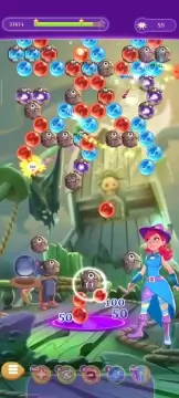 Bubble Witch Saga 3 level screen with mobile HUD and objectives